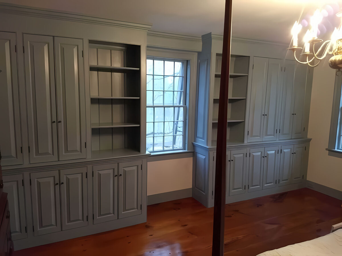 Custom open and closed built-in cabinetry with sage green painted finish, built for an 18th-century home in Southbury, CT