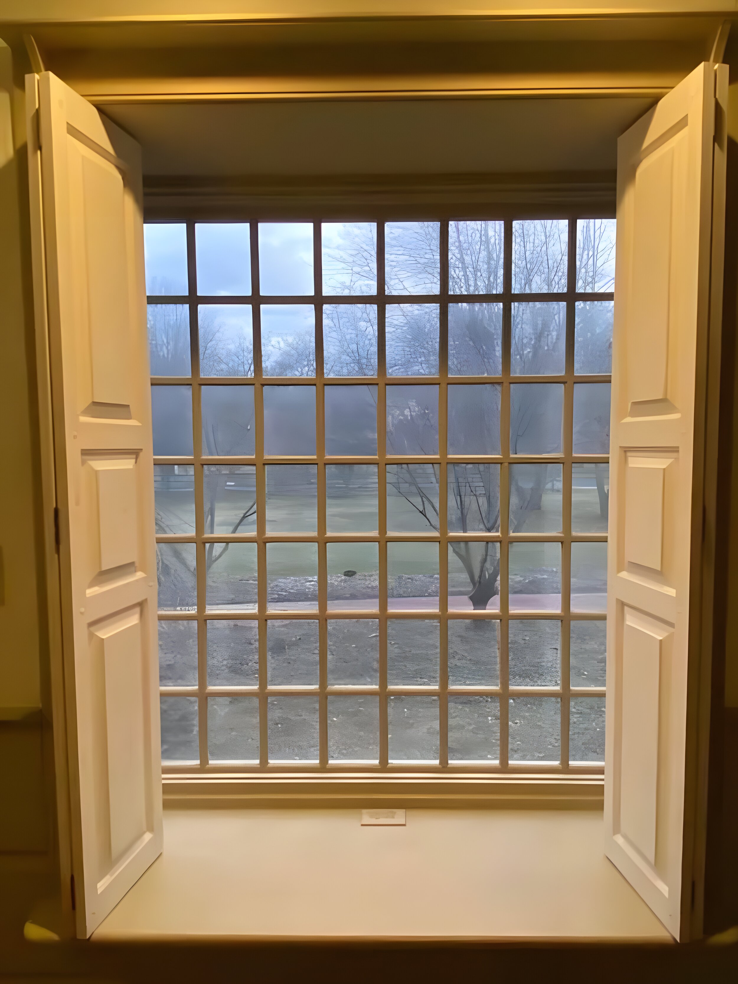 AFTER — white shutters swung fully open revealing large grid-glazed window